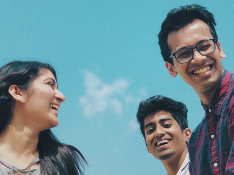 Three residents smile and socialize